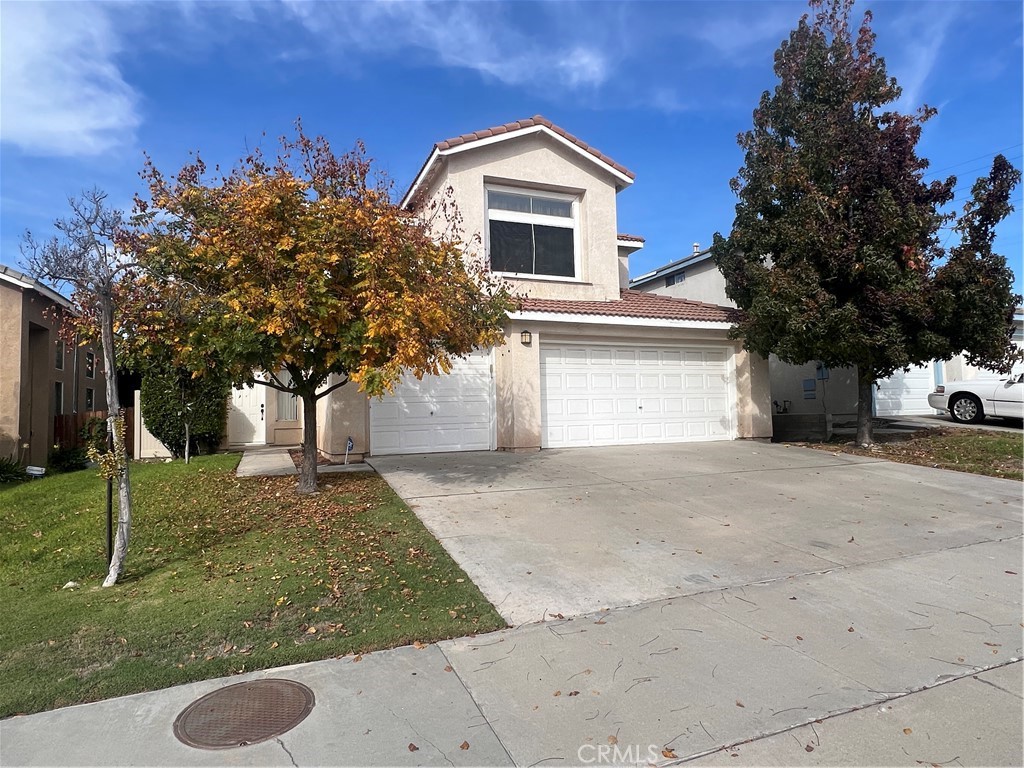 31264 Nice Avenue Mentone, CA 92359 - Photo 2 of 28 a front view of a house with garage