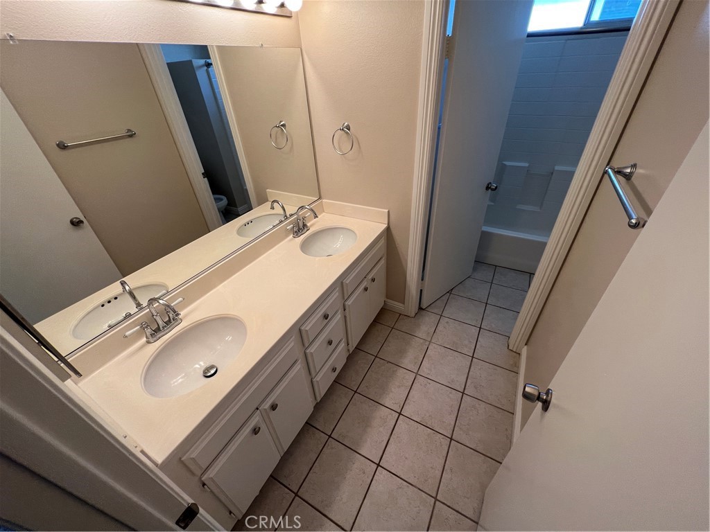 31264 Nice Avenue Mentone, CA 92359 - Photo 23 of 28 a bathroom with a sink mirror and vanity