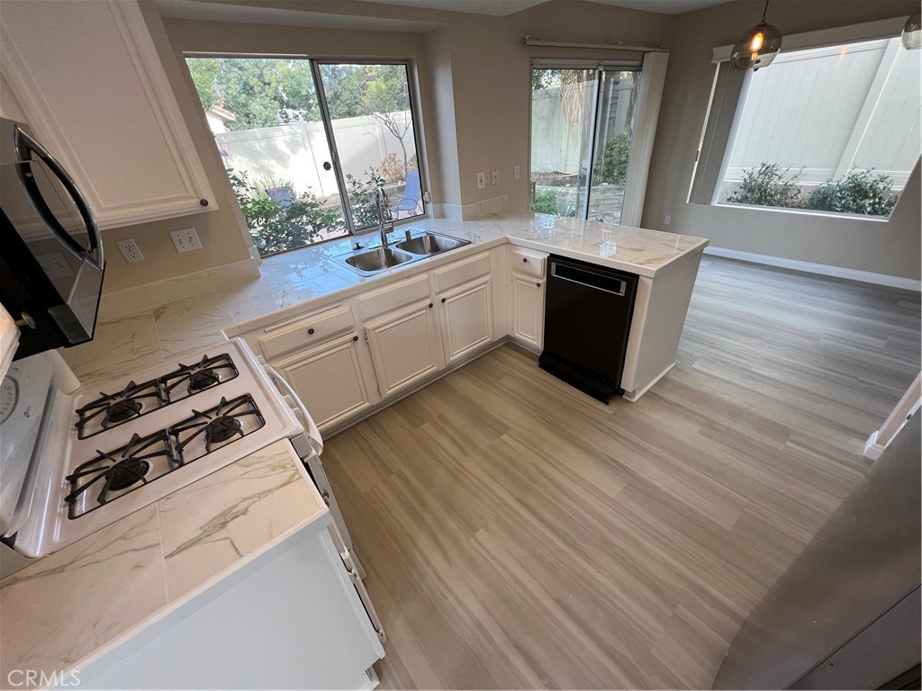 31264 Nice Avenue Mentone, CA 92359 - Photo 4 of 28 a kitchen with a stove a sink and a window