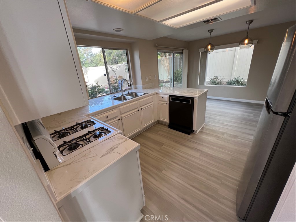 31264 Nice Avenue Mentone, CA 92359 - Photo 7 of 28 a kitchen with sink a stove and refrigerator