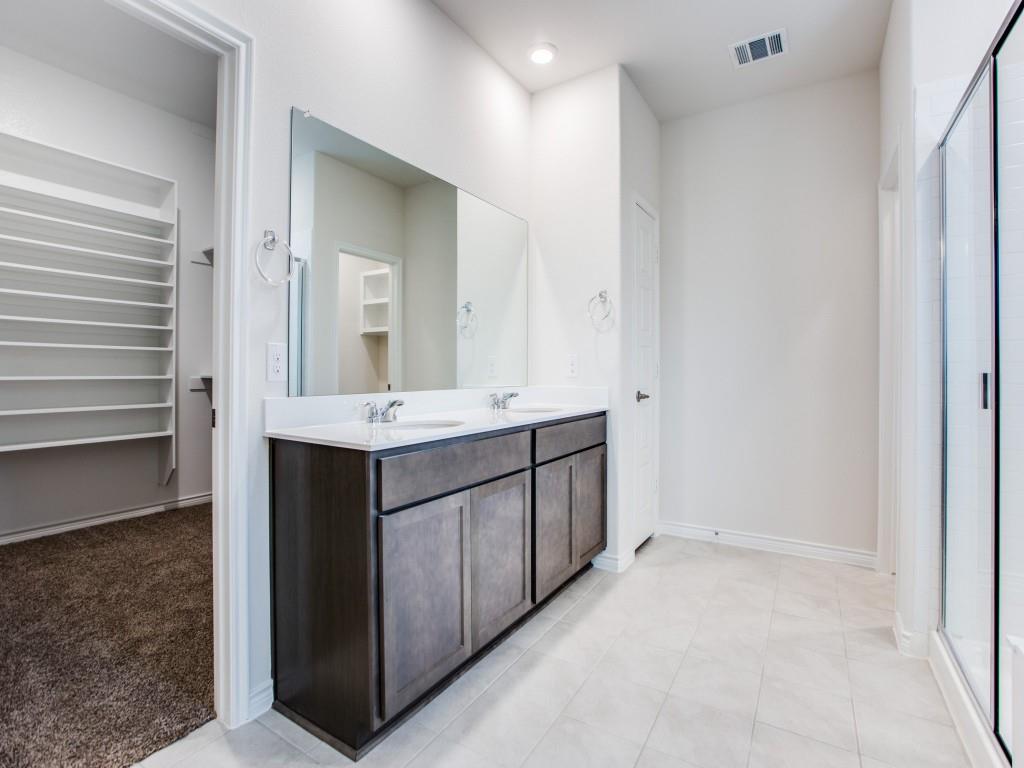 123 Lakeview Circle Pilot Point, TX 76258 - Photo 24 of 39 a bathroom with a double vanity sink a and mirror