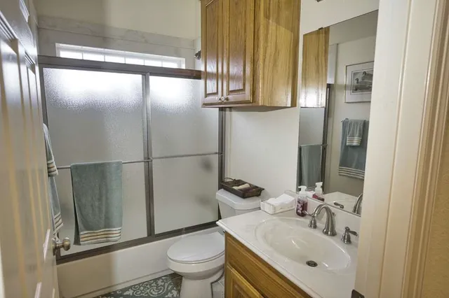 a bathroom with a sink toilet and shower