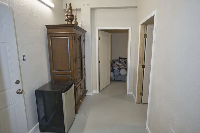 a view of a hallway with some storage and utility room
