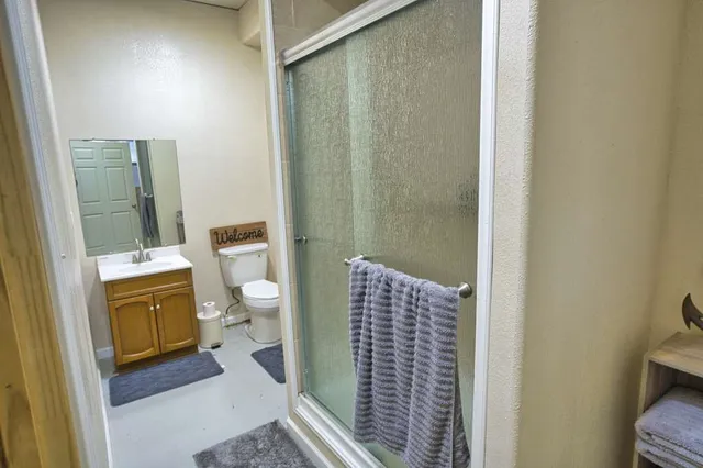 a bathroom with a sink toilet and shower