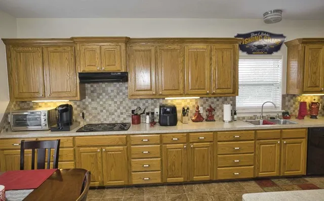 a kitchen with sink and cabinets