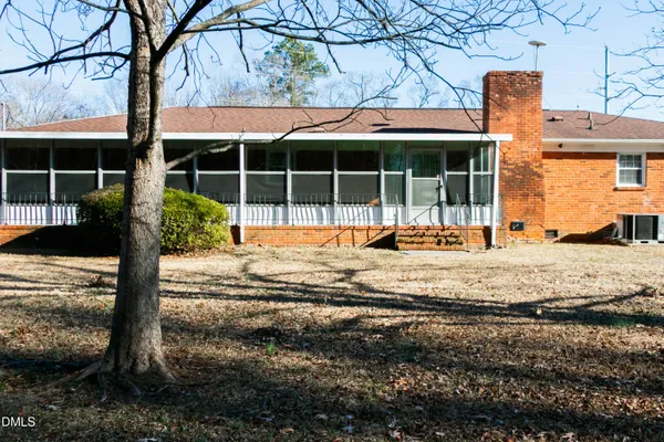 a view of a house with a yard and sitting area