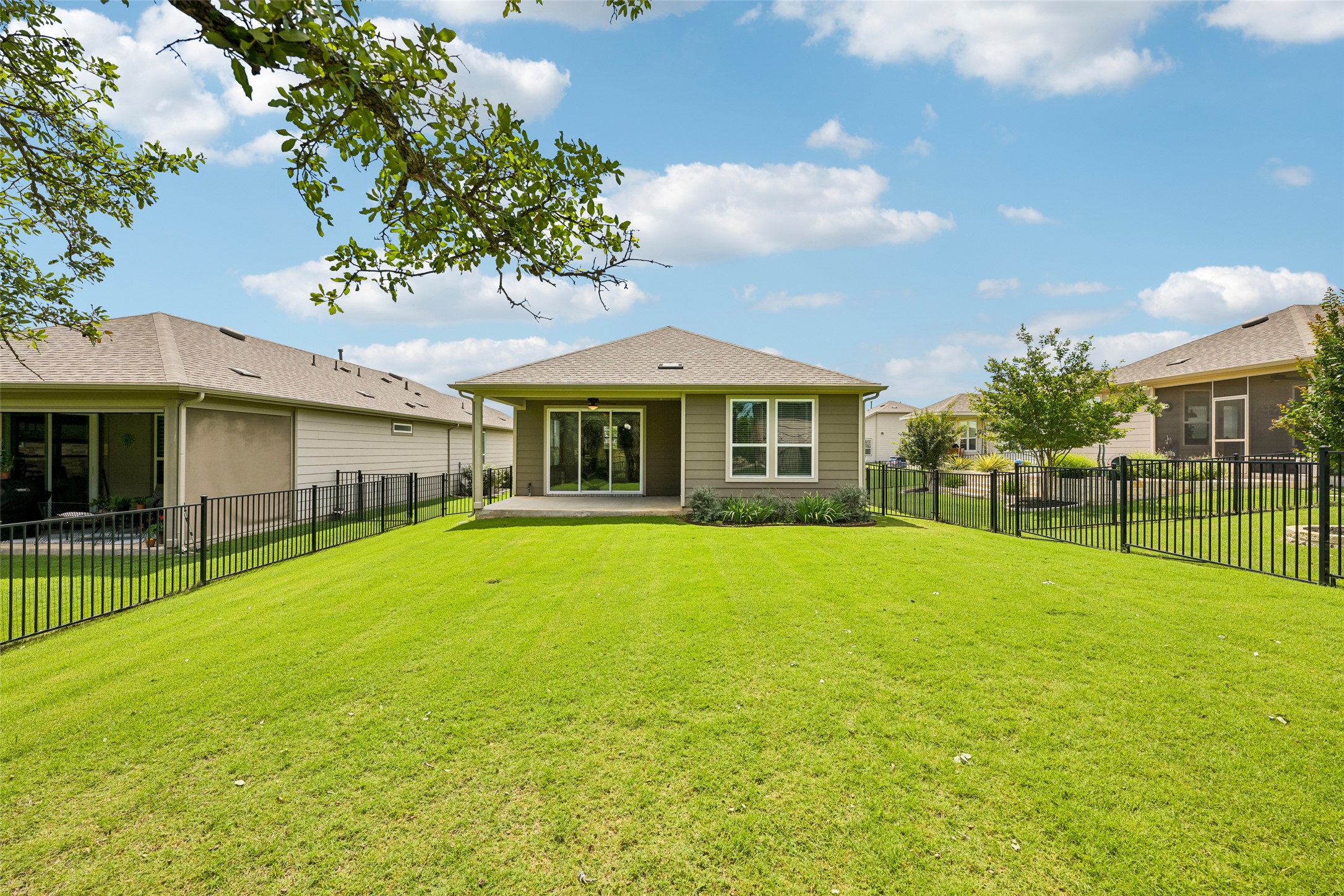 401 Yorktown Street Georgetown, TX 78633 - Photo 33 of 38 Expansive green lawn with a black metal fence enclosing the property