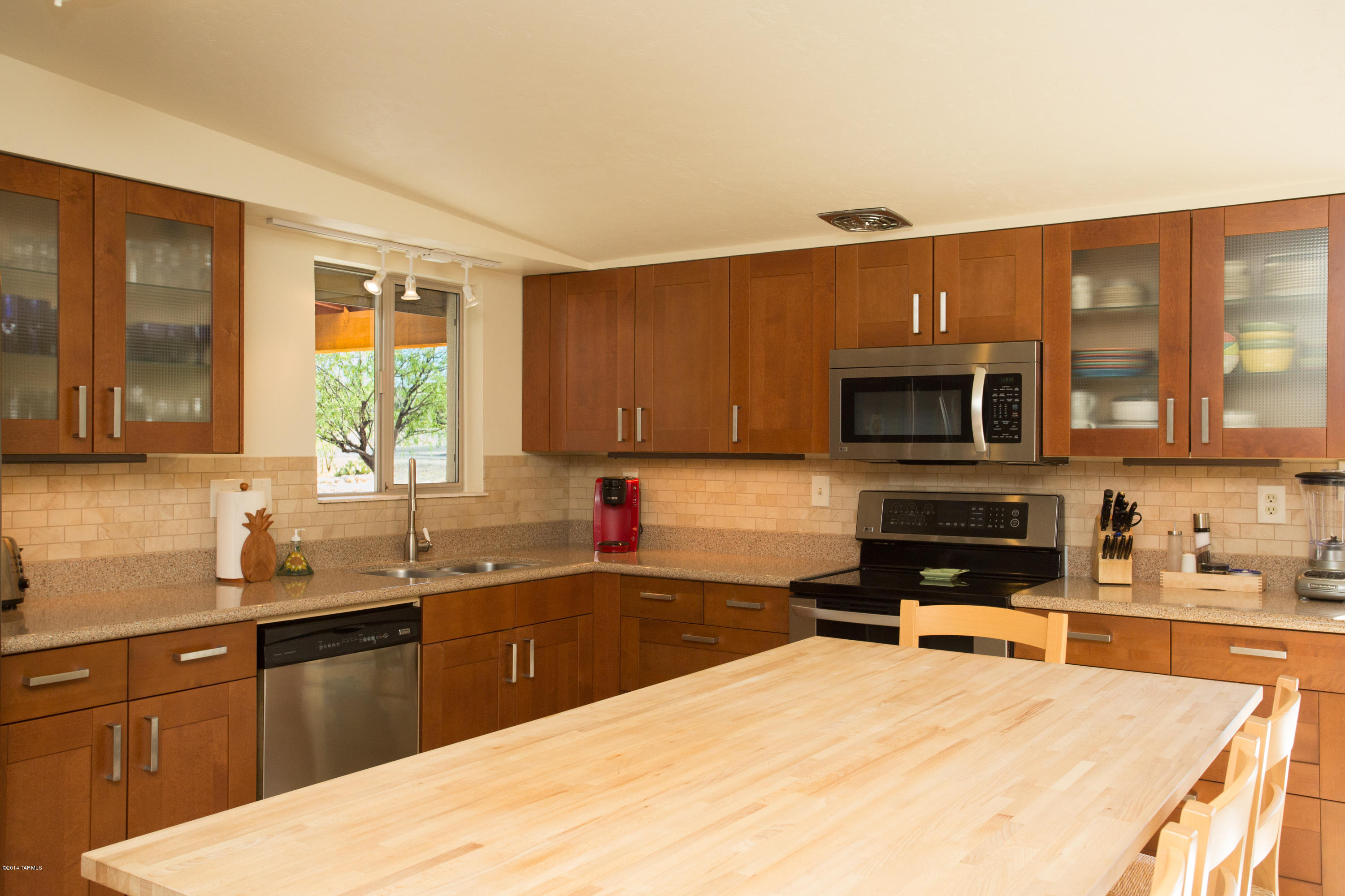3240 North Webster Road Tucson, AZ 85750 - Photo 11 of 26 a kitchen with stainless steel appliances granite countertop a sink stove and microwave