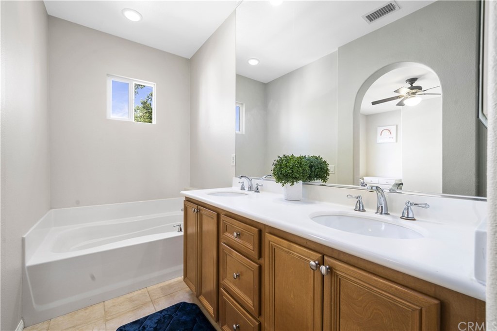 47 Walbert Lane Ladera Ranch, CA 92694 - Photo 14 of 25 a bathroom with a tub sink and mirror