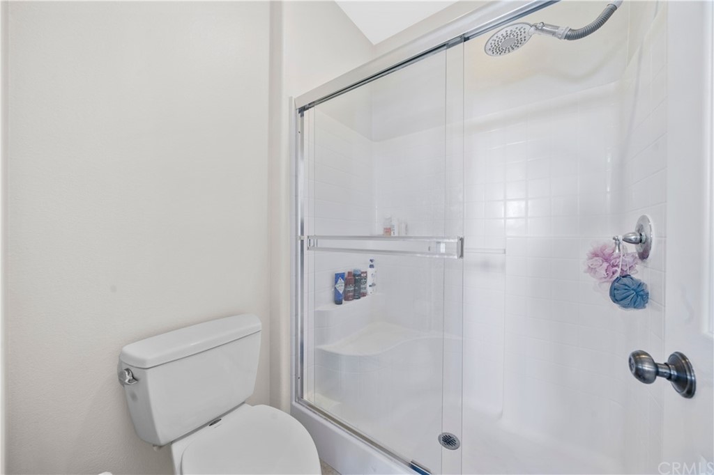 47 Walbert Lane Ladera Ranch, CA 92694 - Photo 15 of 25 a white toilet sitting next to a shower