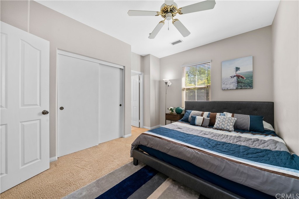 47 Walbert Lane Ladera Ranch, CA 92694 - Photo 17 of 25 a bedroom with a large bed and a chandelier