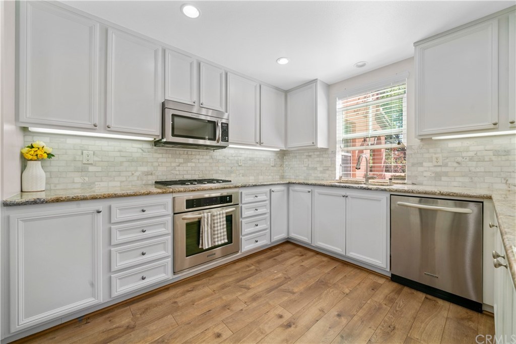 47 Walbert Lane Ladera Ranch, CA 92694 - Photo 7 of 25 a kitchen with granite countertop cabinets stainless steel appliances and sink