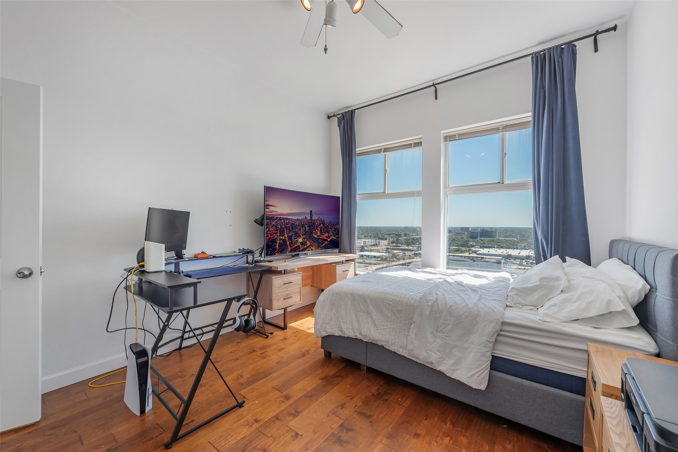 3505 Sage Road, Unit 2210 Houston, TX 77056 - Photo 21 of 40 The secondary bedroom shines with oversized windows and no carpet, flooding the space with natural light and airy charm.