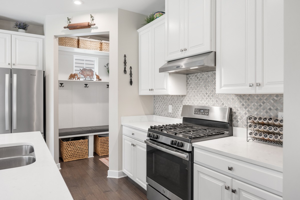 311 Collier Road Mount Juliet, TN 37122 - Photo 12 of 40 a kitchen with stainless steel appliances white cabinets and a stove