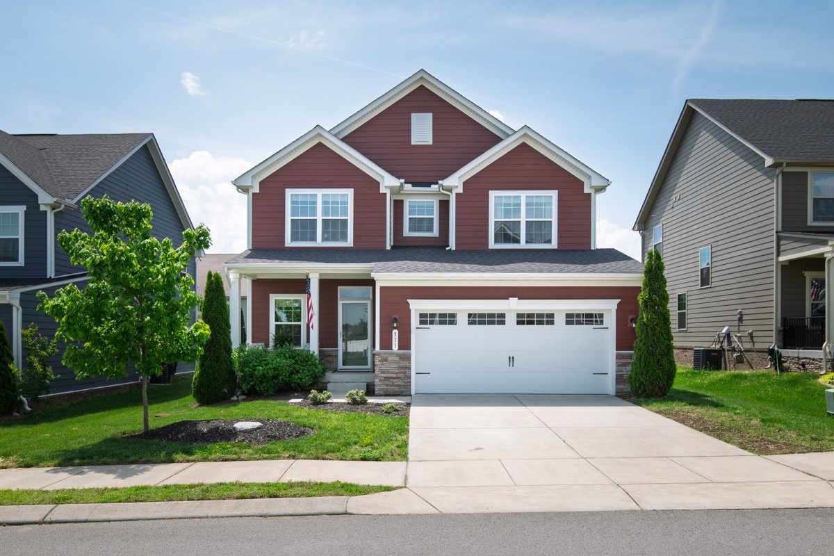 311 Collier Road Mount Juliet, TN 37122 - Photo 2 of 40 a front view of a house with a yard and garage