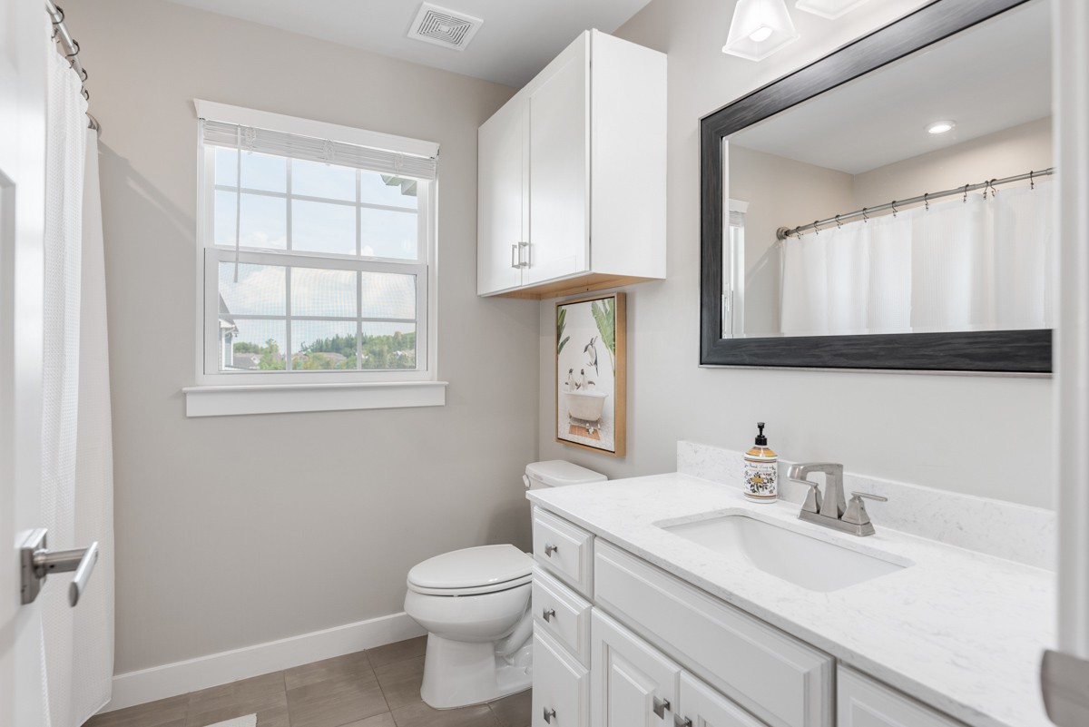 311 Collier Road Mount Juliet, TN 37122 - Photo 26 of 40 a bathroom with a toilet a sink a mirror and a window