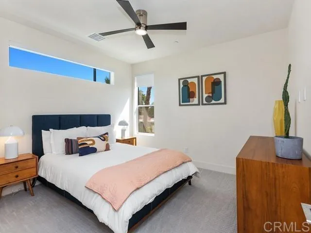 a bedroom with a bed and a couch