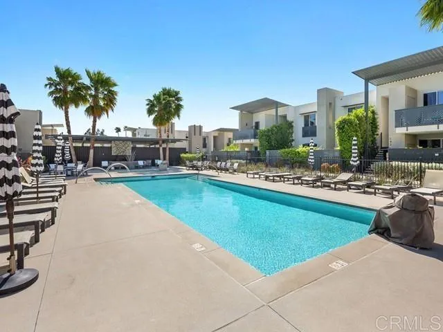 a swimming pool with outdoor seating and yard