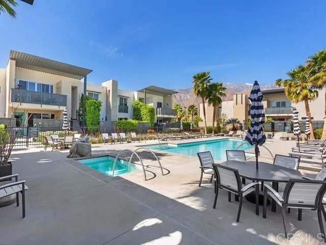 a backyard of a house with table and chairs