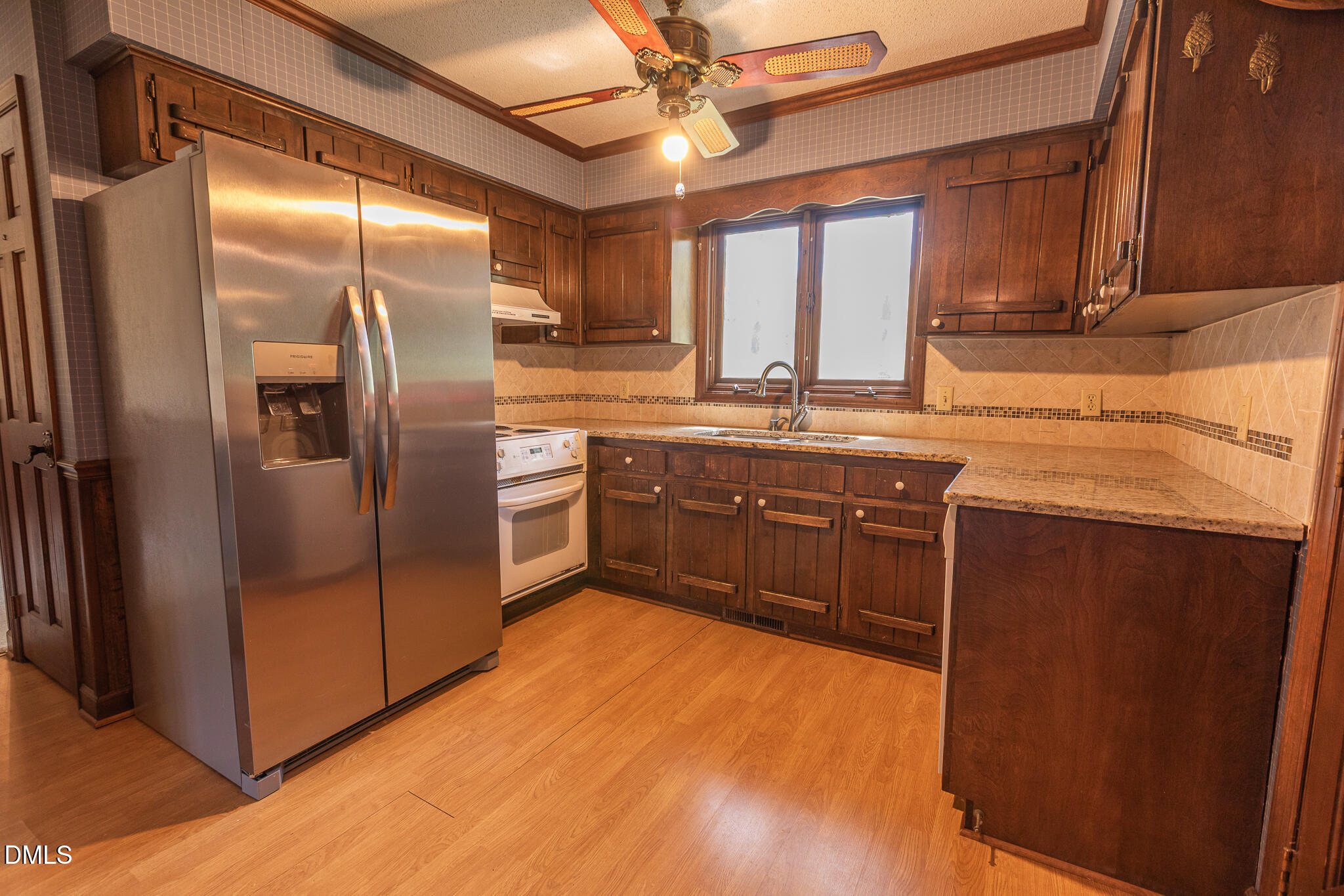 6119 Splitrock Trail Apex, NC 27539 - Photo 17 of 58 a kitchen with stainless steel appliances granite countertop a refrigerator a sink a stove and island