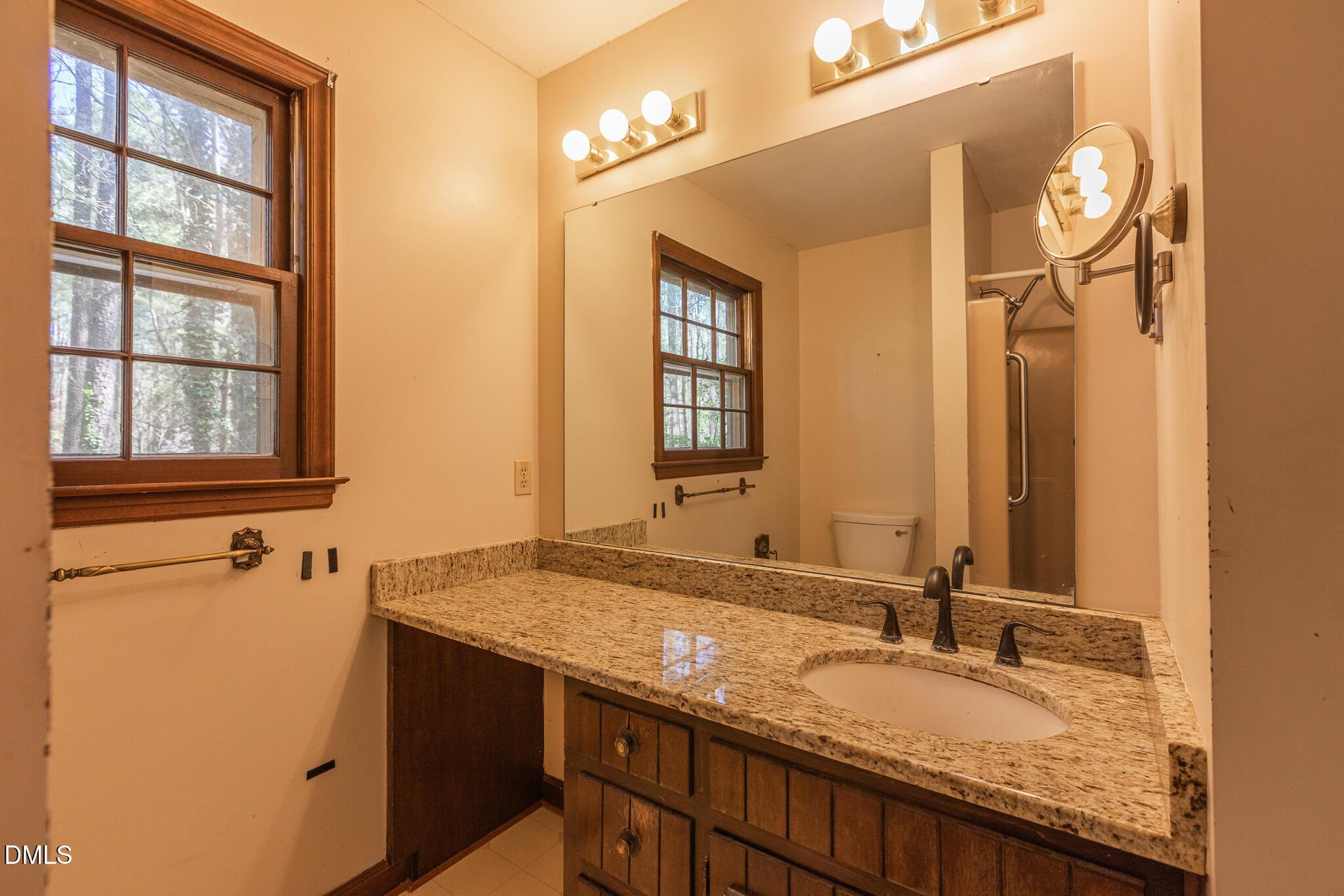 6119 Splitrock Trail Apex, NC 27539 - Photo 22 of 58 a bathroom with a granite countertop sink and a mirror