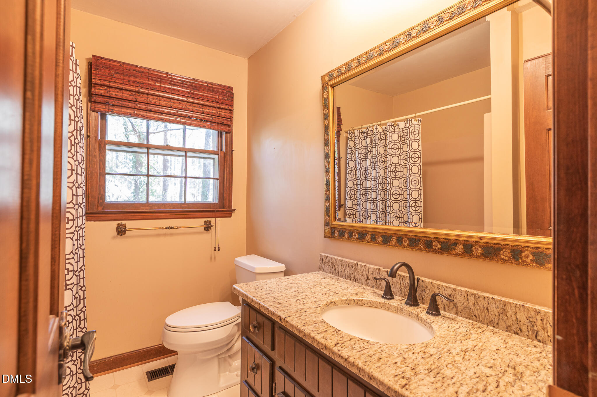 6119 Splitrock Trail Apex, NC 27539 - Photo 26 of 58 a bathroom with a granite countertop sink toilet and mirror