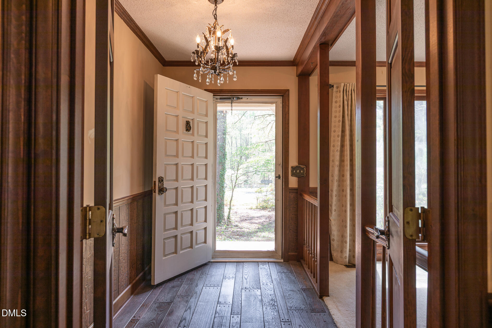 6119 Splitrock Trail Apex, NC 27539 - Photo 9 of 58 a view of a hallway with wooden floor and staircase