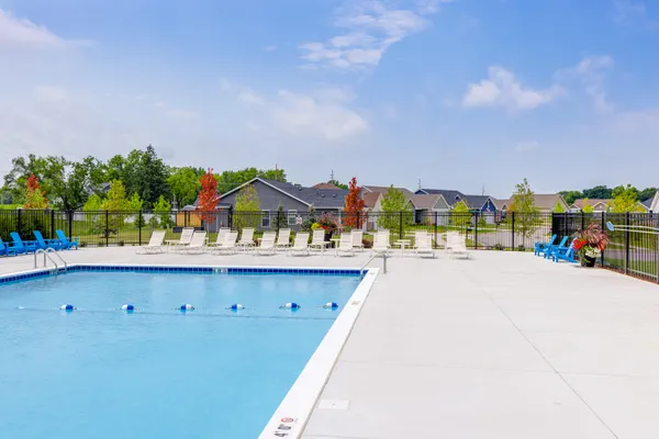 a view of swimming pool with outdoor seating and city in back