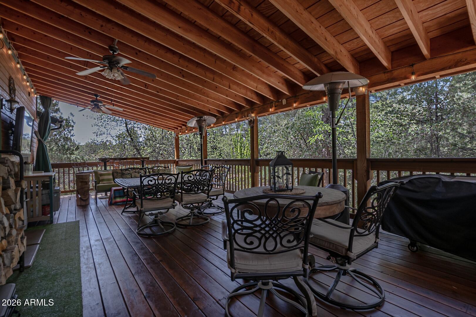 3762 Watertank Road Pine, AZ 85544 - Photo 25 of 38 a view of a chairs and table in patio with wooden floor