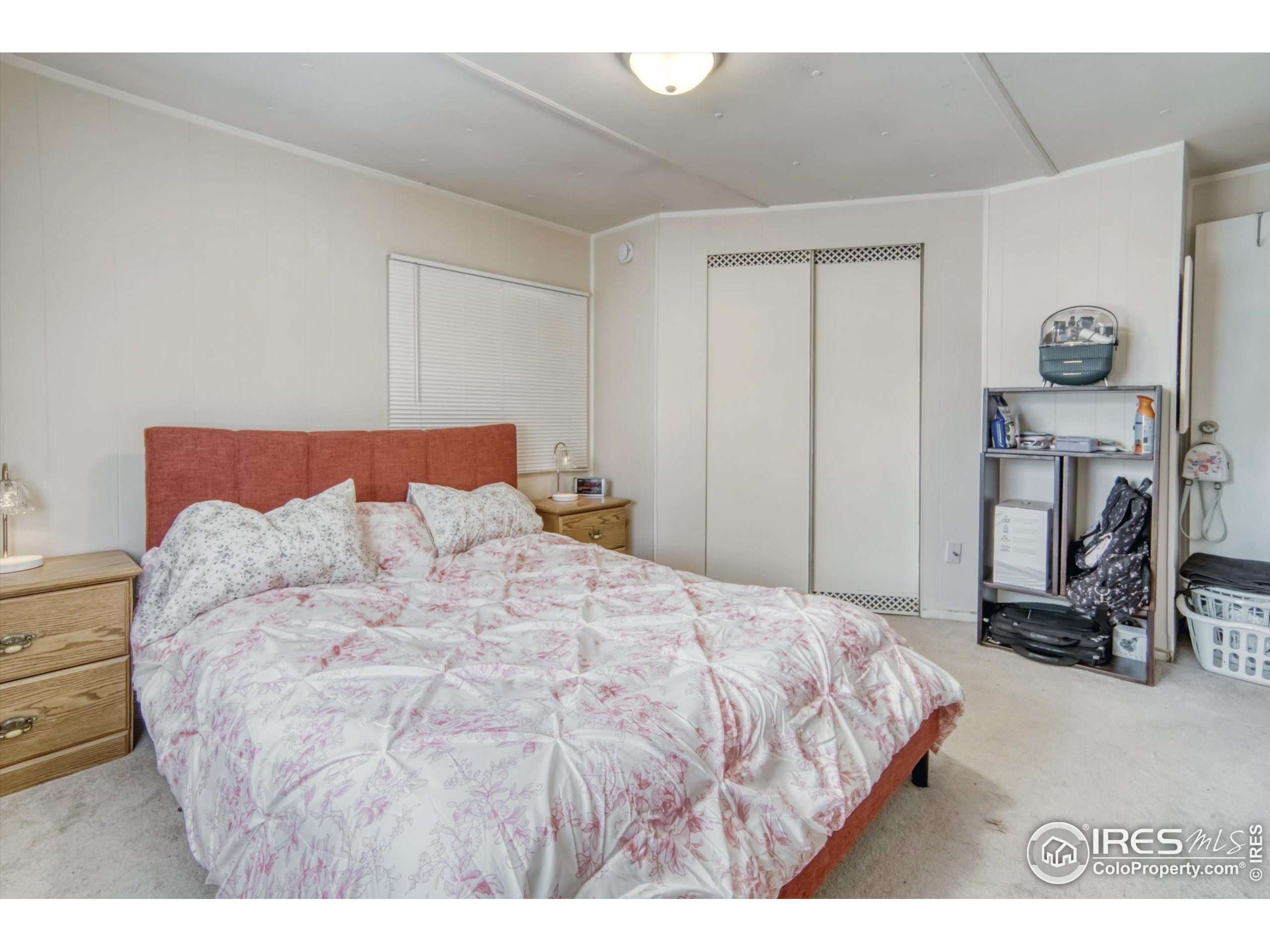 5000 Butte Street, Unit 272 Boulder, CO 80301 - Photo 13 of 21 a large bed sitting in a bedroom next to a window