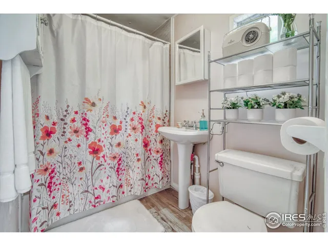 a bathroom with a sink toilet and mirror
