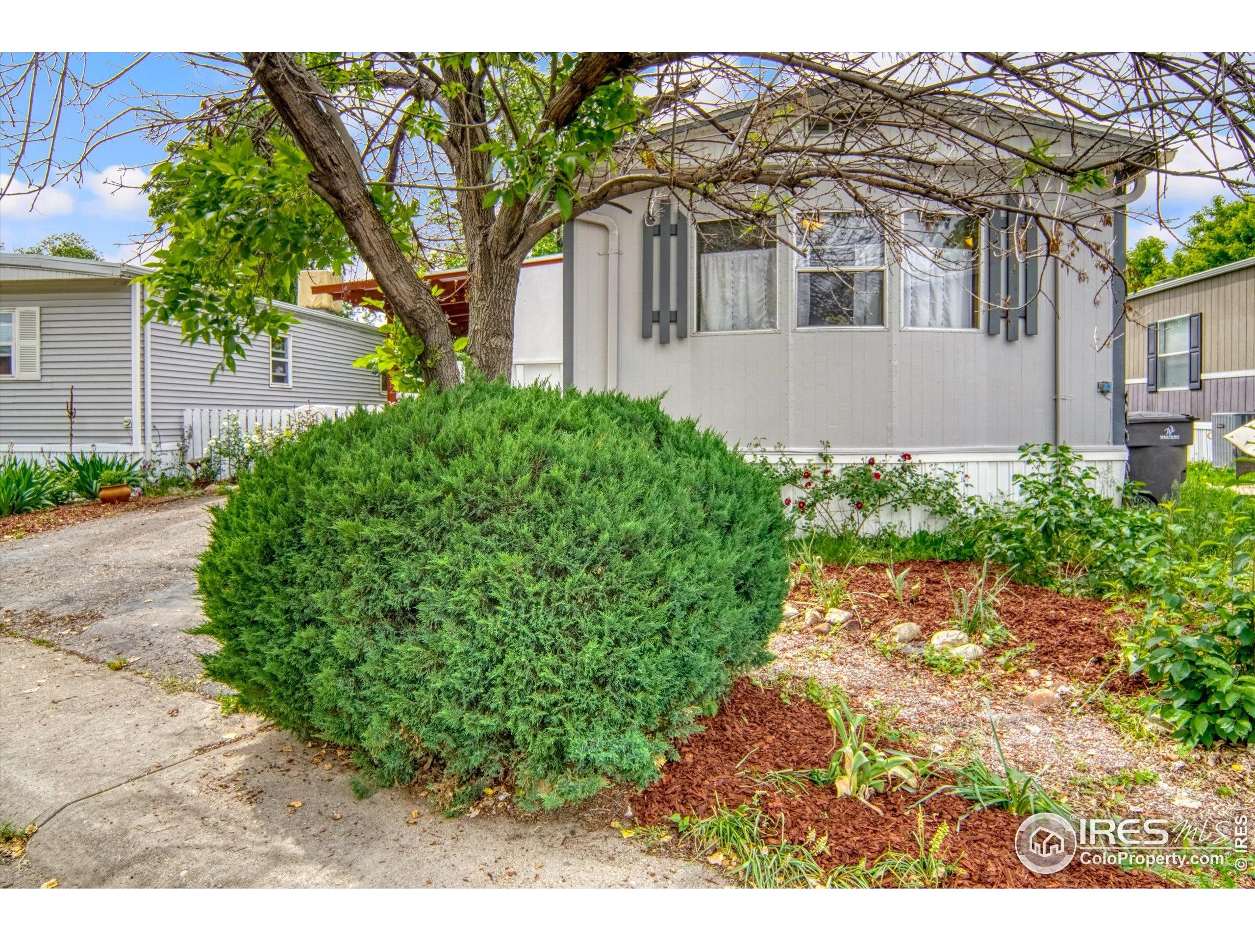 5000 Butte Street, Unit 272 Boulder, CO 80301 - Photo 2 of 21 a front view of a house with a yard