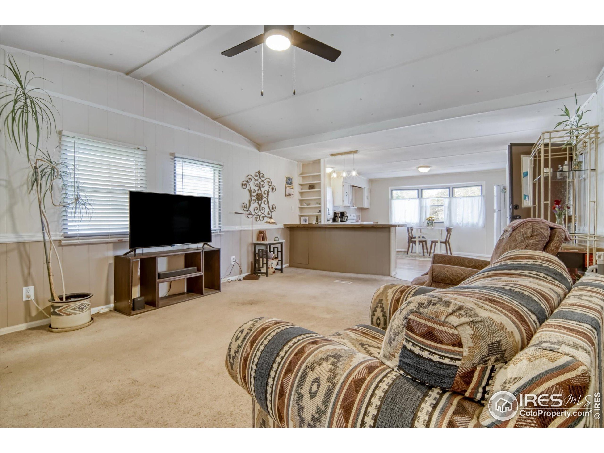 5000 Butte Street, Unit 272 Boulder, CO 80301 - Photo 9 of 21 a living room with furniture and a flat screen tv