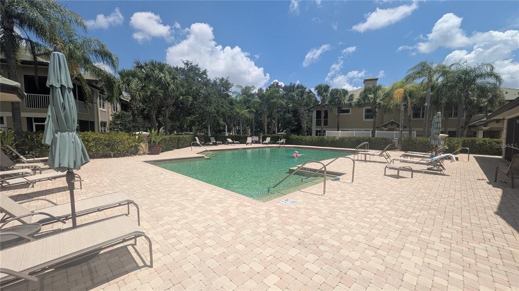 6552 Moorings Point Circle, Unit 102 Lakewood Ranch, FL 34202 - Photo 37 of 57 a view of a swimming pool with a patio