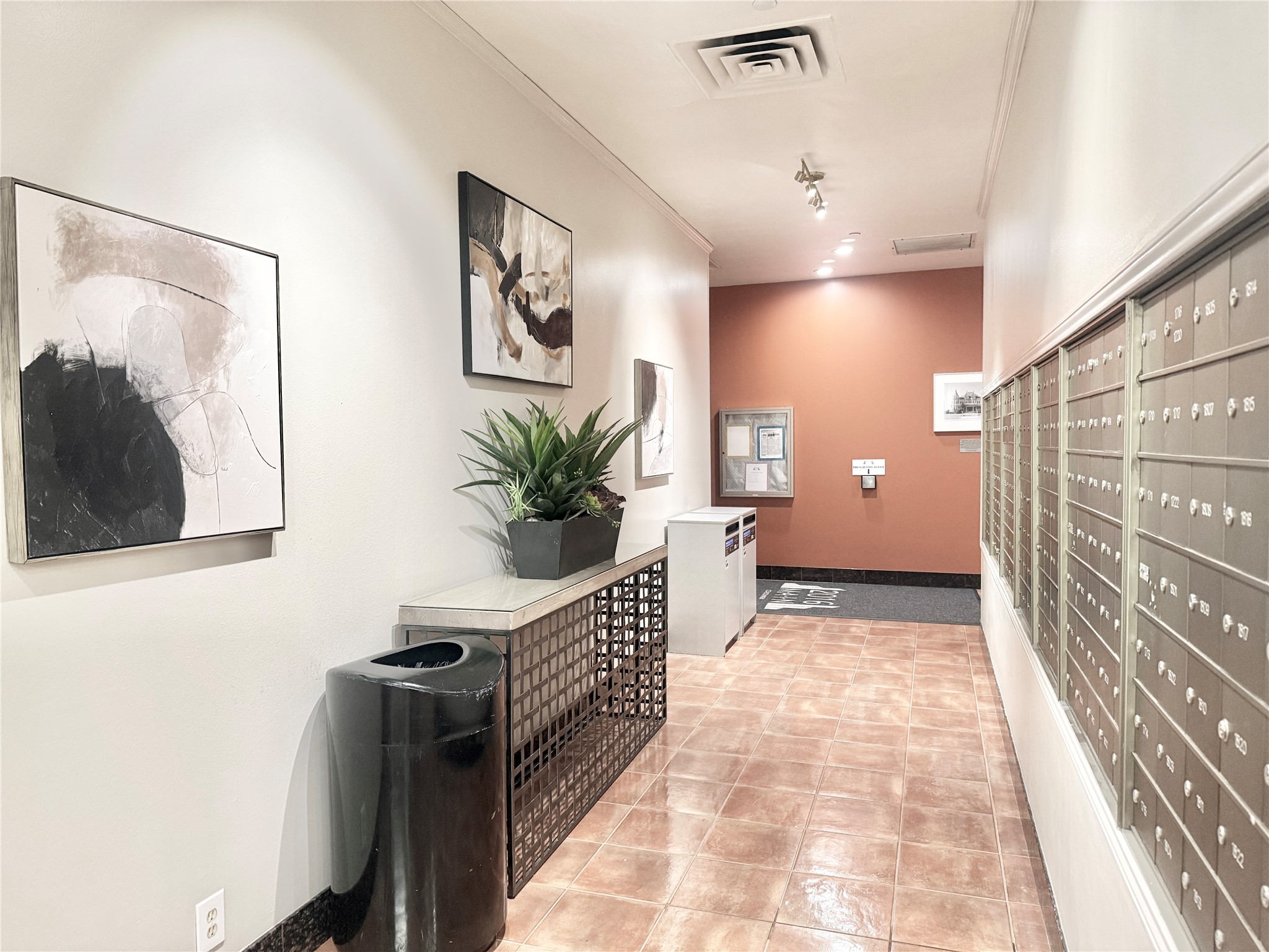 2016 Main Street, Unit 1022 Houston, TX 77002 - Photo 43 of 48 a hallway with a potted plant on a table and a painting