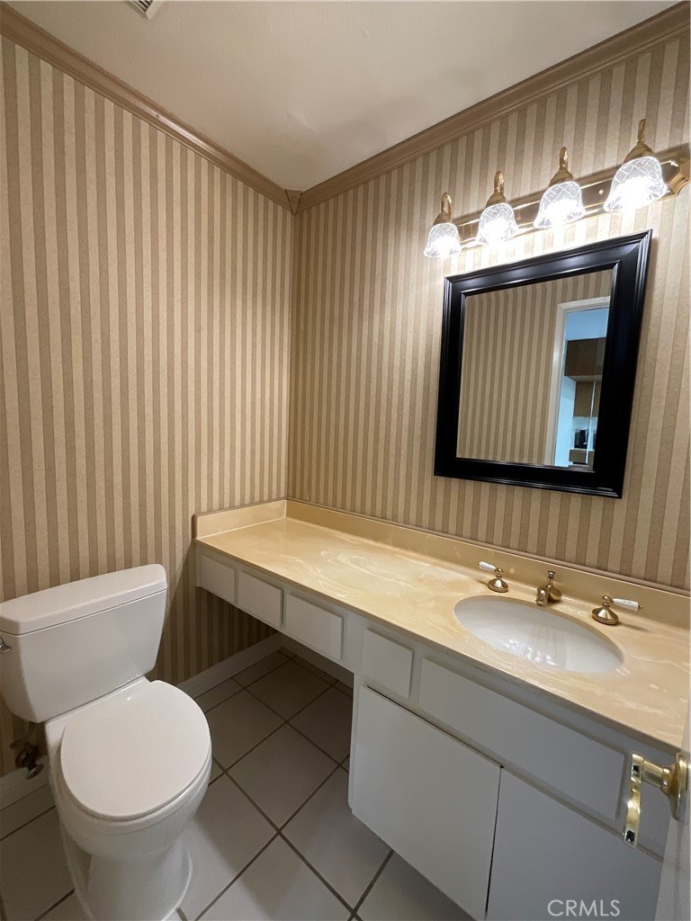 7053 Seawind Drive Long Beach, CA 90803 - Photo 14 of 47 a bathroom with a toilet a sink and mirror