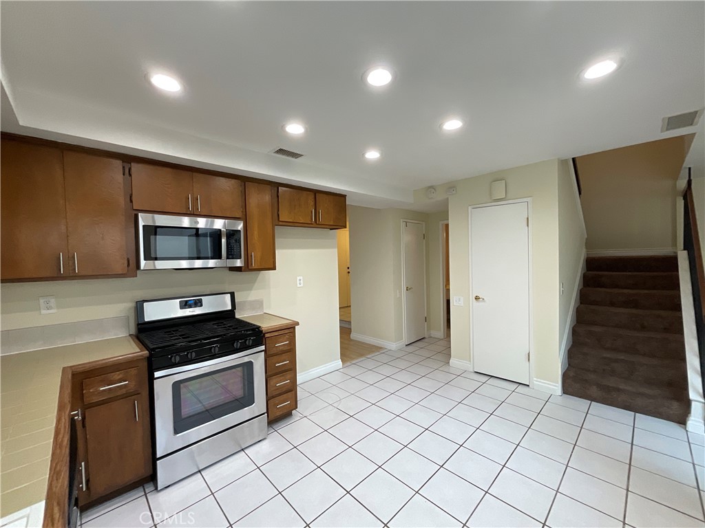 7053 Seawind Drive Long Beach, CA 90803 - Photo 15 of 47 a kitchen with stainless steel appliances a refrigerator and a stove top oven