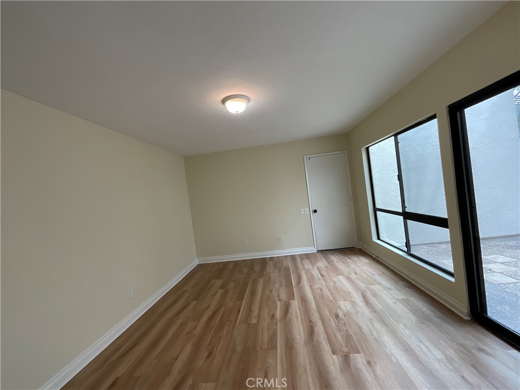 7053 Seawind Drive Long Beach, CA 90803 - Photo 18 of 47 wooden floor in an empty room with a window
