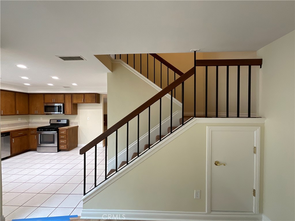 7053 Seawind Drive Long Beach, CA 90803 - Photo 20 of 47 a view of staircase with lots of wooden furniture