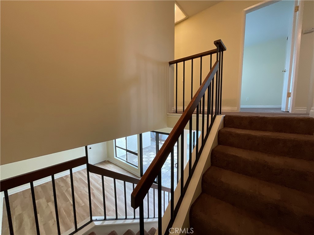 7053 Seawind Drive Long Beach, CA 90803 - Photo 21 of 47 a view of staircase with lots of frames on wall