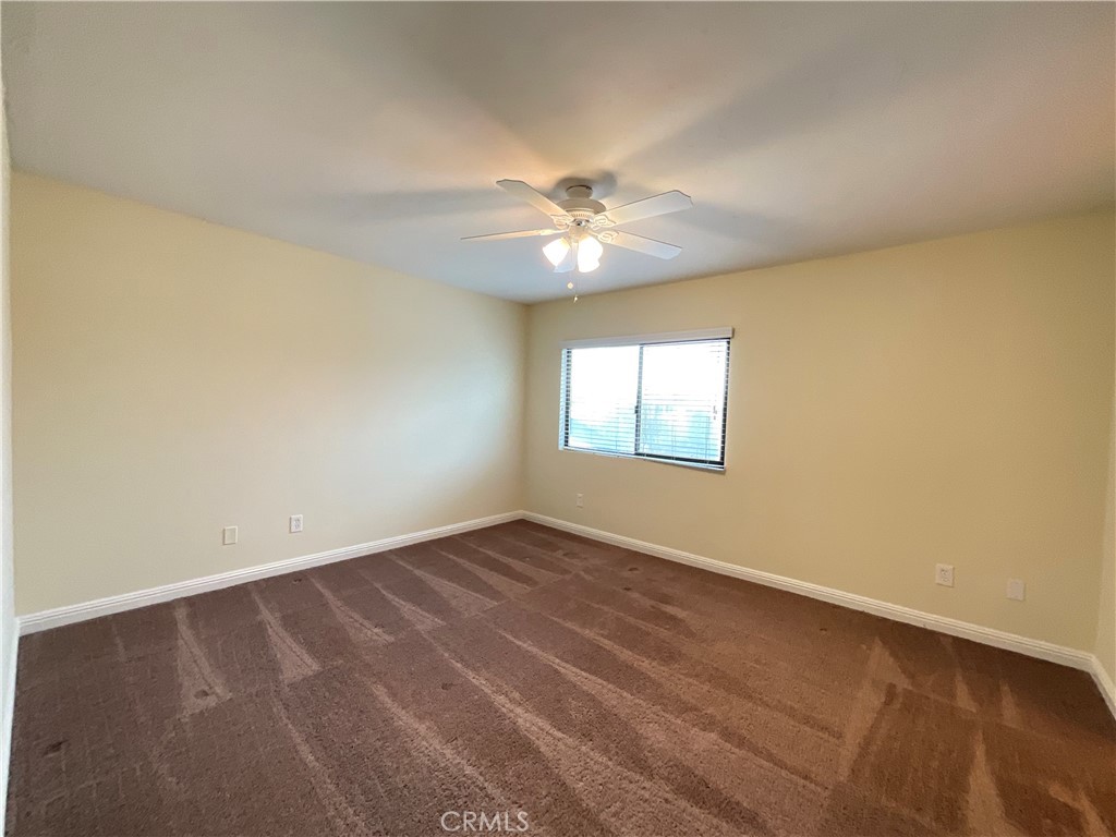 7053 Seawind Drive Long Beach, CA 90803 - Photo 23 of 47 an empty room with windows and fan