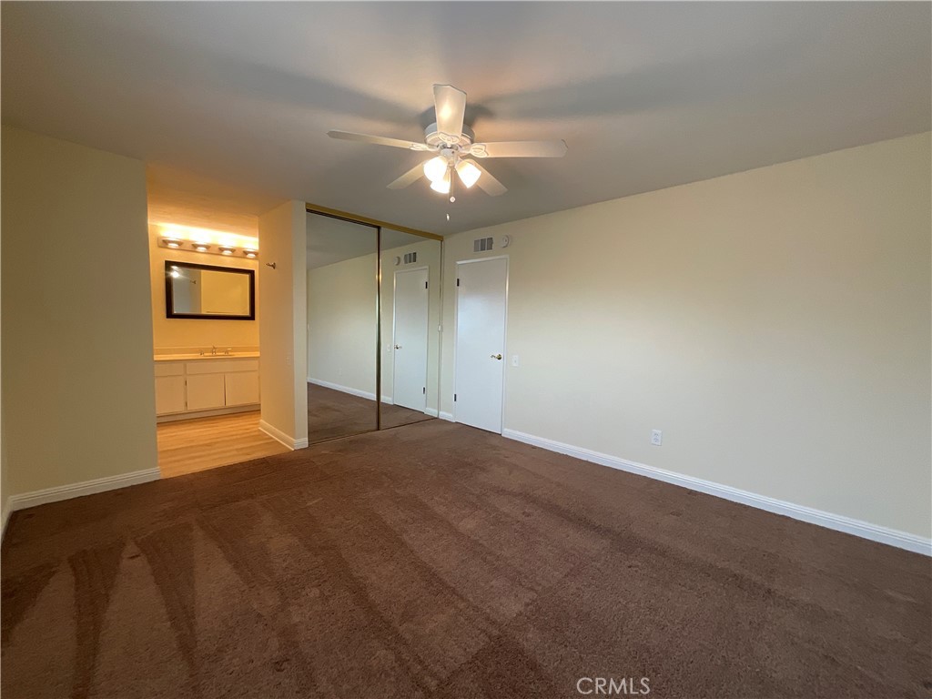 7053 Seawind Drive Long Beach, CA 90803 - Photo 25 of 47 an empty room with a empty space and a ceiling fan