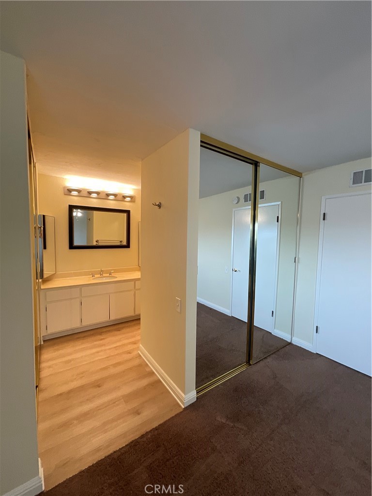 7053 Seawind Drive Long Beach, CA 90803 - Photo 27 of 47 a view of a hallway with wooden floor