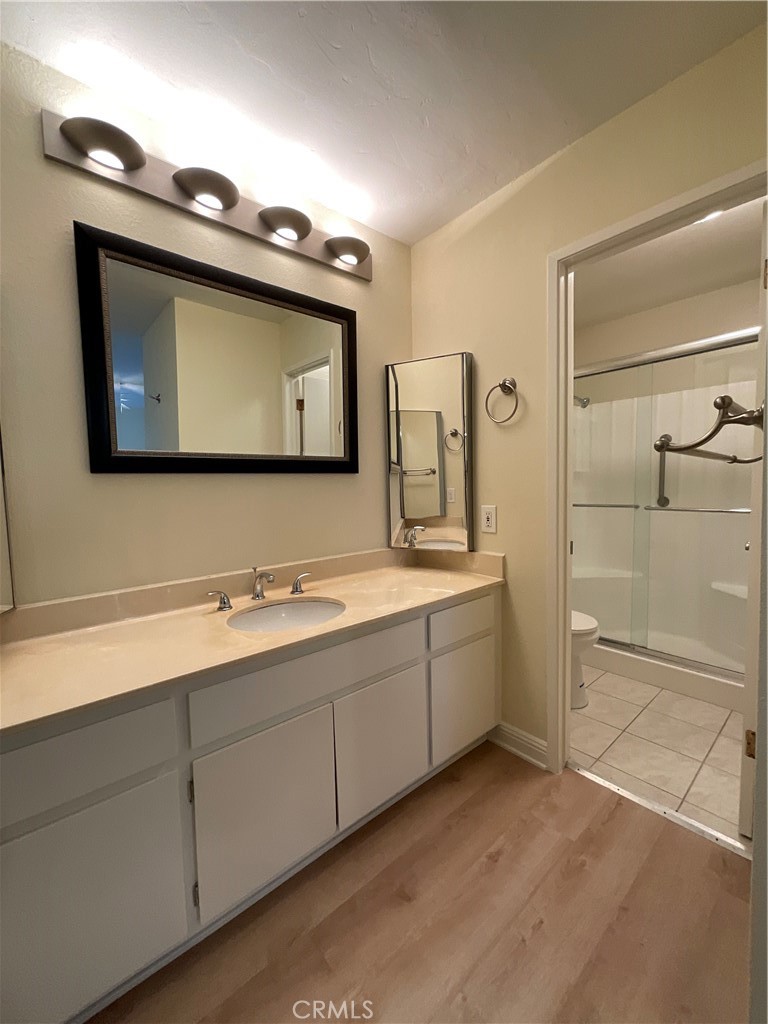 7053 Seawind Drive Long Beach, CA 90803 - Photo 29 of 47 a bathroom with a toilet sink and mirror