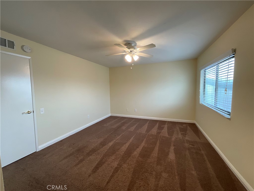 7053 Seawind Drive Long Beach, CA 90803 - Photo 31 of 47 an empty room with windows and fan