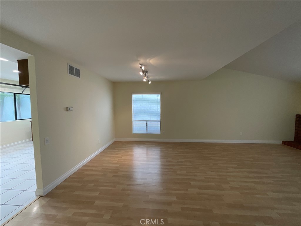 7053 Seawind Drive Long Beach, CA 90803 - Photo 5 of 47 a view of an empty room with wooden floor and a window