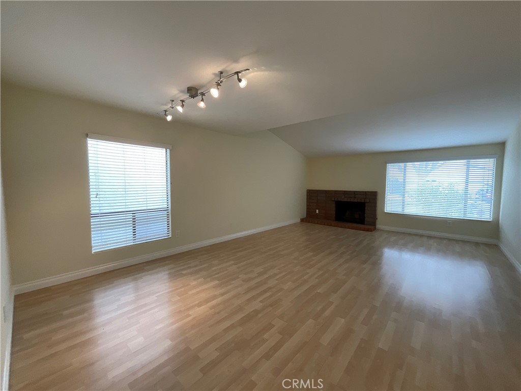 7053 Seawind Drive Long Beach, CA 90803 - Photo 6 of 47 an empty room with wooden floor and windows