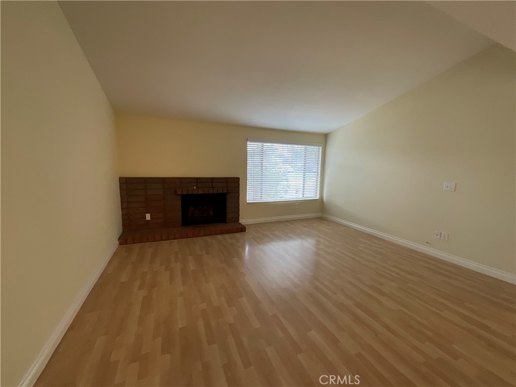7053 Seawind Drive Long Beach, CA 90803 - Photo 9 of 47 a view of empty room with wooden floor and fireplace