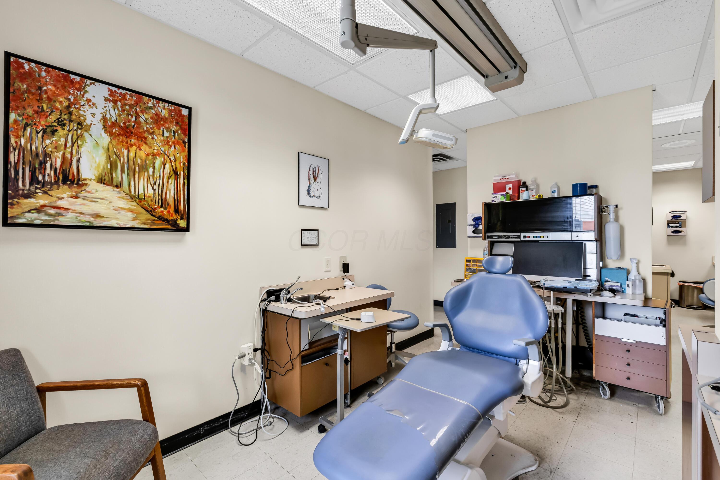 1240 Crescent Heights Road Marion, OH 43302 - Photo 41 of 60 • Neutral vinyl flooring • Ivory painted walls • Acoustic ceiling tiles • Fluorescent lighting • Enclosed vanity with single bowl, stainless steel sinktop • Divider • Lighting & equipment do not remain • Plumbed for oxygen & nitrogen