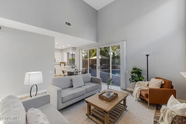 a living room with furniture kitchen view and a table
